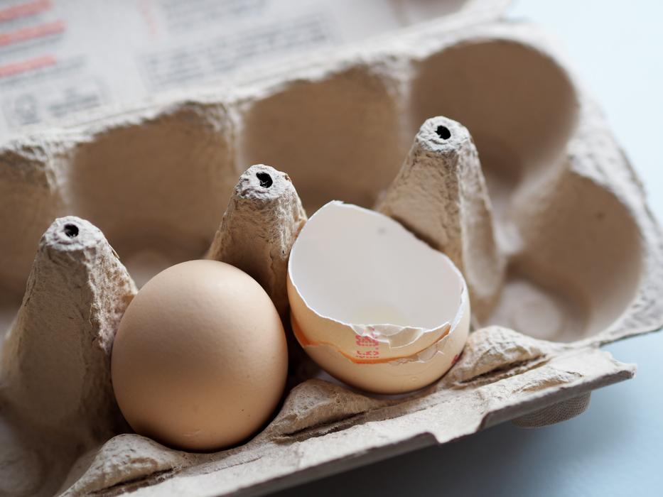 Egg and eggshell in the cardboard package