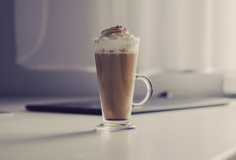Glass of beautiful latte with whipped cream