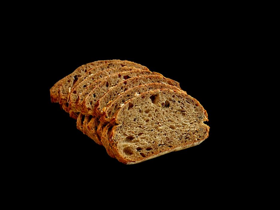 Close-up of the beautiful, brown bread slices, at black background