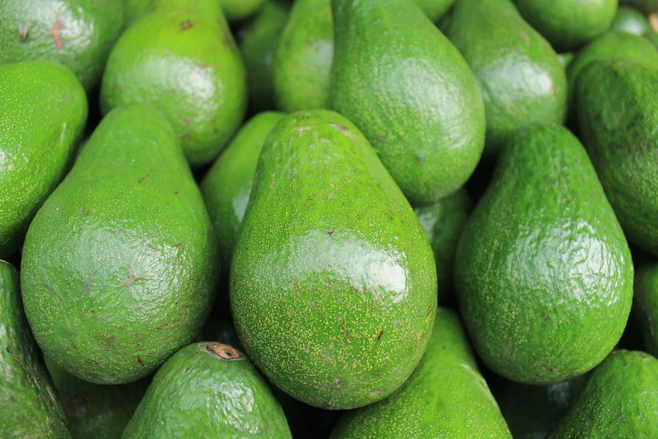 Macro photo of the shiny, green avocados together