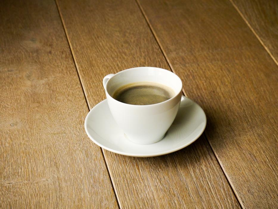 a cup of espresso on the floor
