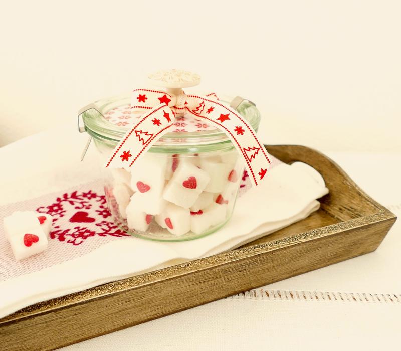 Close-up of the jar of sugar cubes, with red and white ribbon