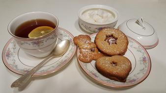 Cutlery with tea, and beautiful Lintserskoe cookies on the plate