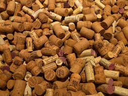 Close-up of the brown and beige bottle corks with signs, of different shades, in the pile