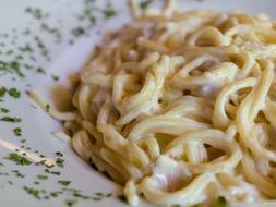 italian pasta carbonara on a plate in a restaurant