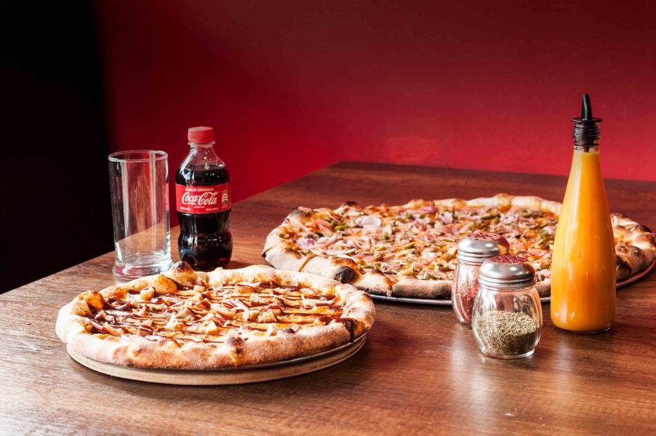 pizza and coca cola on the table in the restaurant