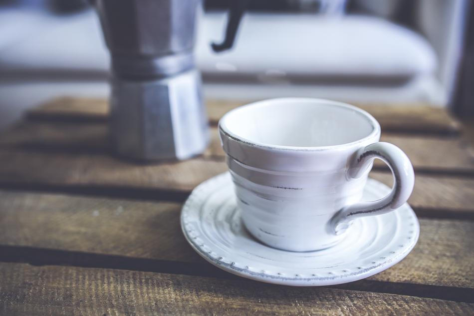 White cup on the background of the teapot