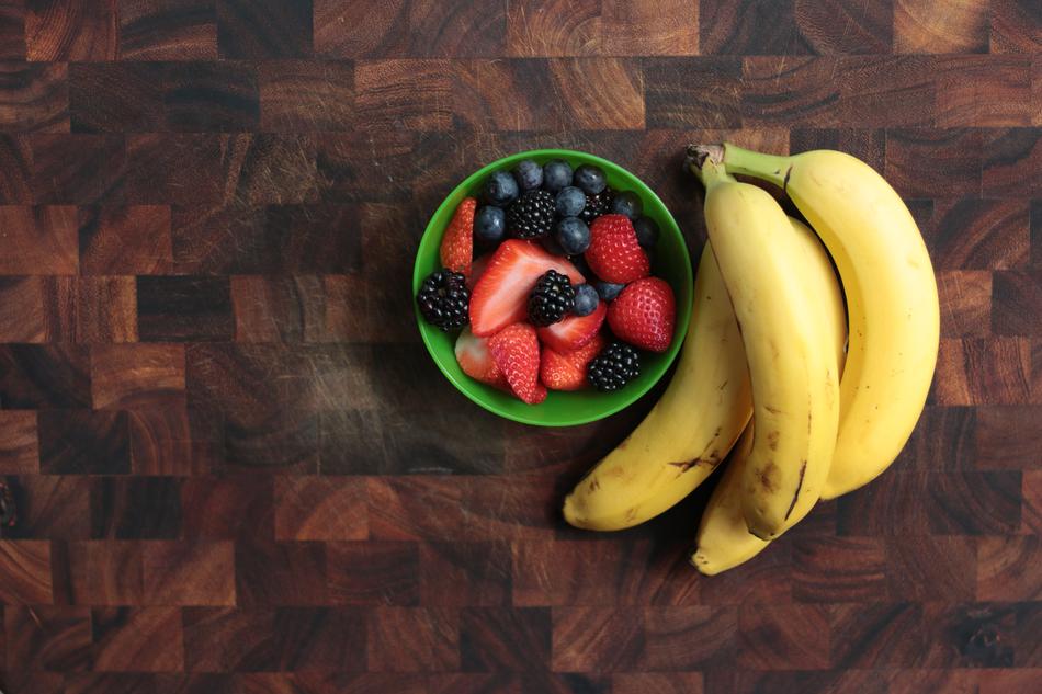 banana cluster and Berries in bowl
