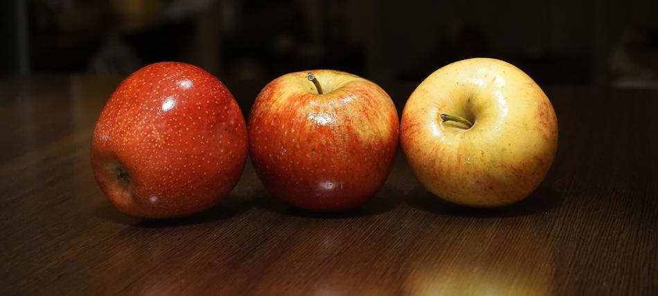 three apples on table