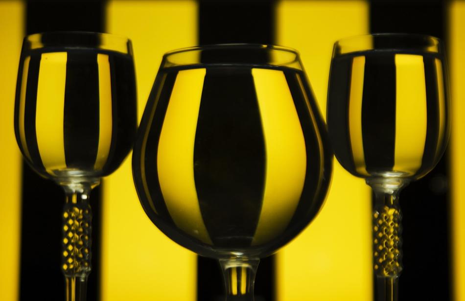 glass with drink on yellow and black background