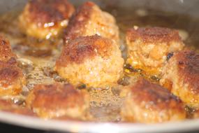 Meatballs roasting on pan close up