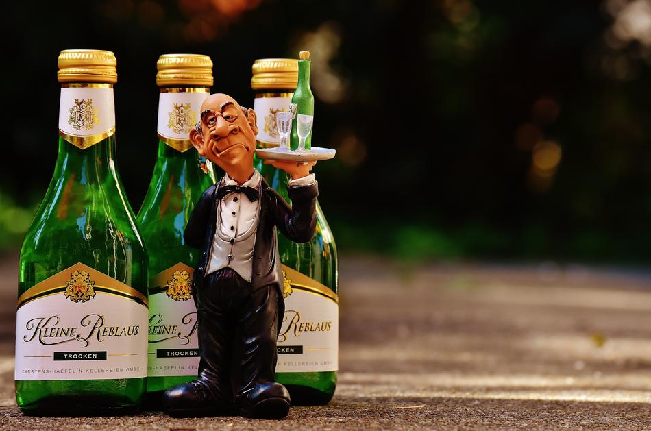 Statue of the bartender by bottles