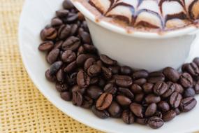 fragrant coffee beans near the cup