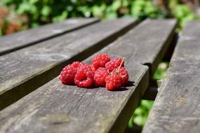 ripe Raspberry on weathered wooden plank
