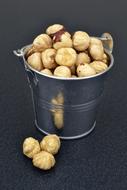 metal bucket with hazelnuts