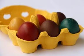 colored eggs in yellow box