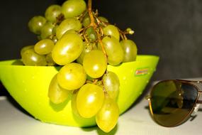 grapes in green bowl and sunglasses