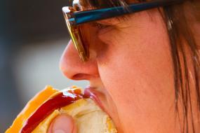 man eats hot dog