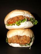 two Hamburgers in stack at black background