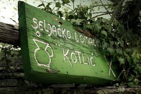 white lettering on green sign