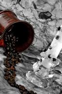 coffee beans in mug near candle