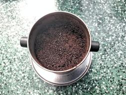 coffee beans in an iron cup