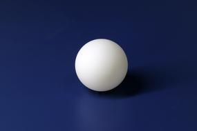 white Ping-Pong ball on the blue background