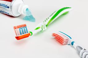 two toothbrushes and toothpaste