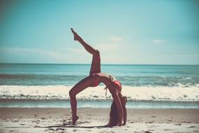 woman in bikini practicing yoga