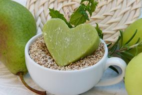 apple soap lies on the grains in a cup
