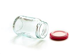 empty glass container with red lid