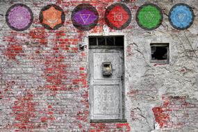 painted sacred signs on a brick wall of a building