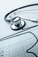 a stethoscope lies on a cardiogram