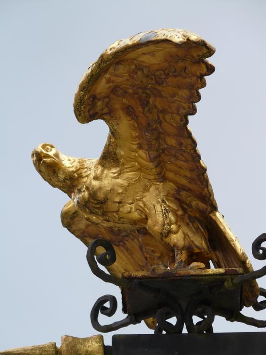 Golden eagle, vintage wrought iron figure on street sign