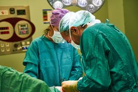 team of doctors working in the operating room