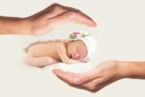 newborn baby between protective hands, collage