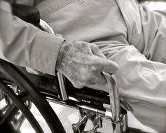 Black and white photo of the senior man on wheelchair
