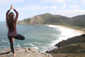 lonely athlete is doing yoga on the beach