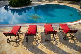 luxury empty Sunbeds at Pool