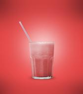 strawberry smoothie in a glass on a pink background