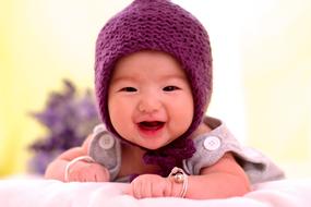 baby in a purple knitted hat