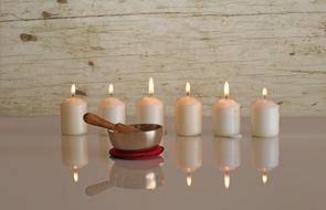 singing bowl and burning candles for relaxation