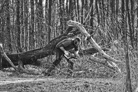 monochrome photo of a forester with a saw