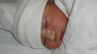 newborn under a white sheet