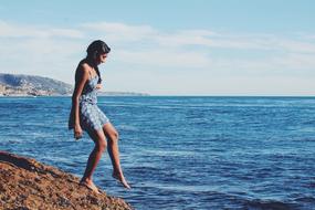 girl tests water in the sea