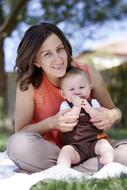 mother with baby on the lawn in the park