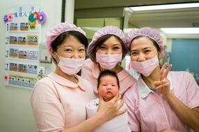 nurses with a newborn