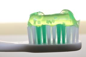 Toothbrush with green Toothpaste, macro