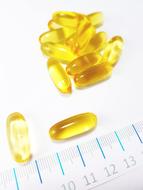 fish oil capsules and ruler