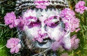 Buddha face with violet flowers